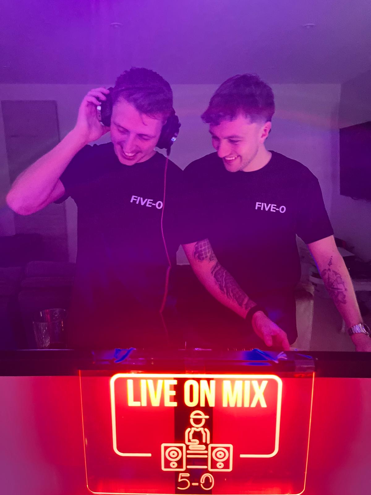 Five-O DJs performing with red neon lighting